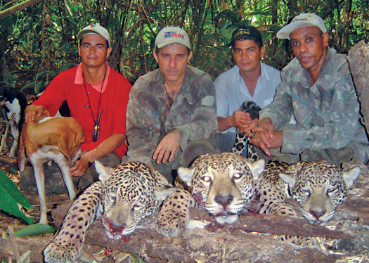 Temístocles Barbosa Freire (second from left) and other alleged members of a poaching ring pose with dead jaguars in photo federal police copied from a confiscated cell phone.